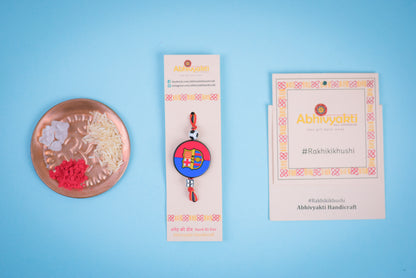Lovely kids rakhi adorned with beads, showcasing Barcelona football badge on ribbon with soccer ball.