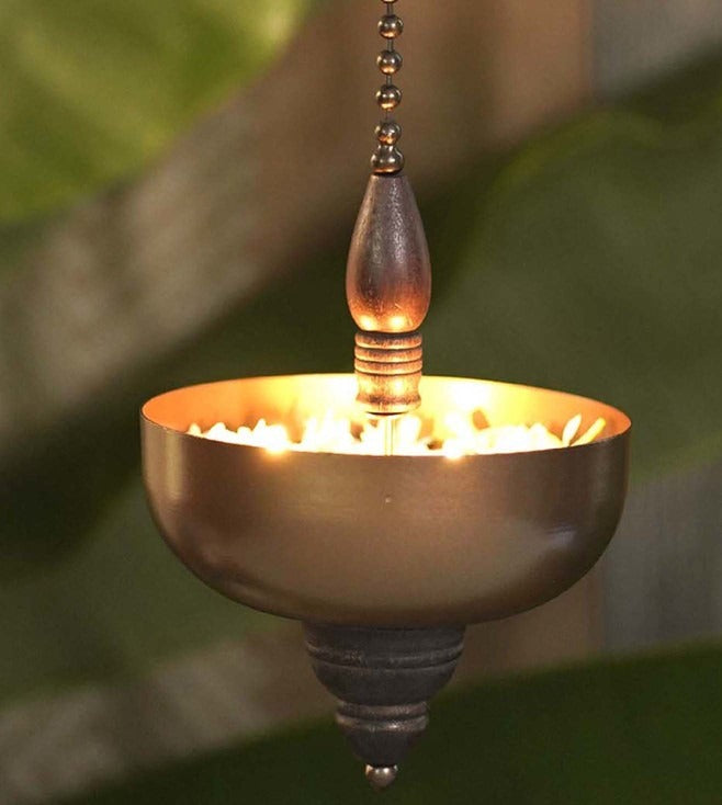 "Elegant wall-mounted Diwali diyas with intricate metal holders, designed to hang on the wall for a unique and stylish look. The diyas cast a soft, flickering light, creating a serene and festive ambiance for Diwali celebrations."