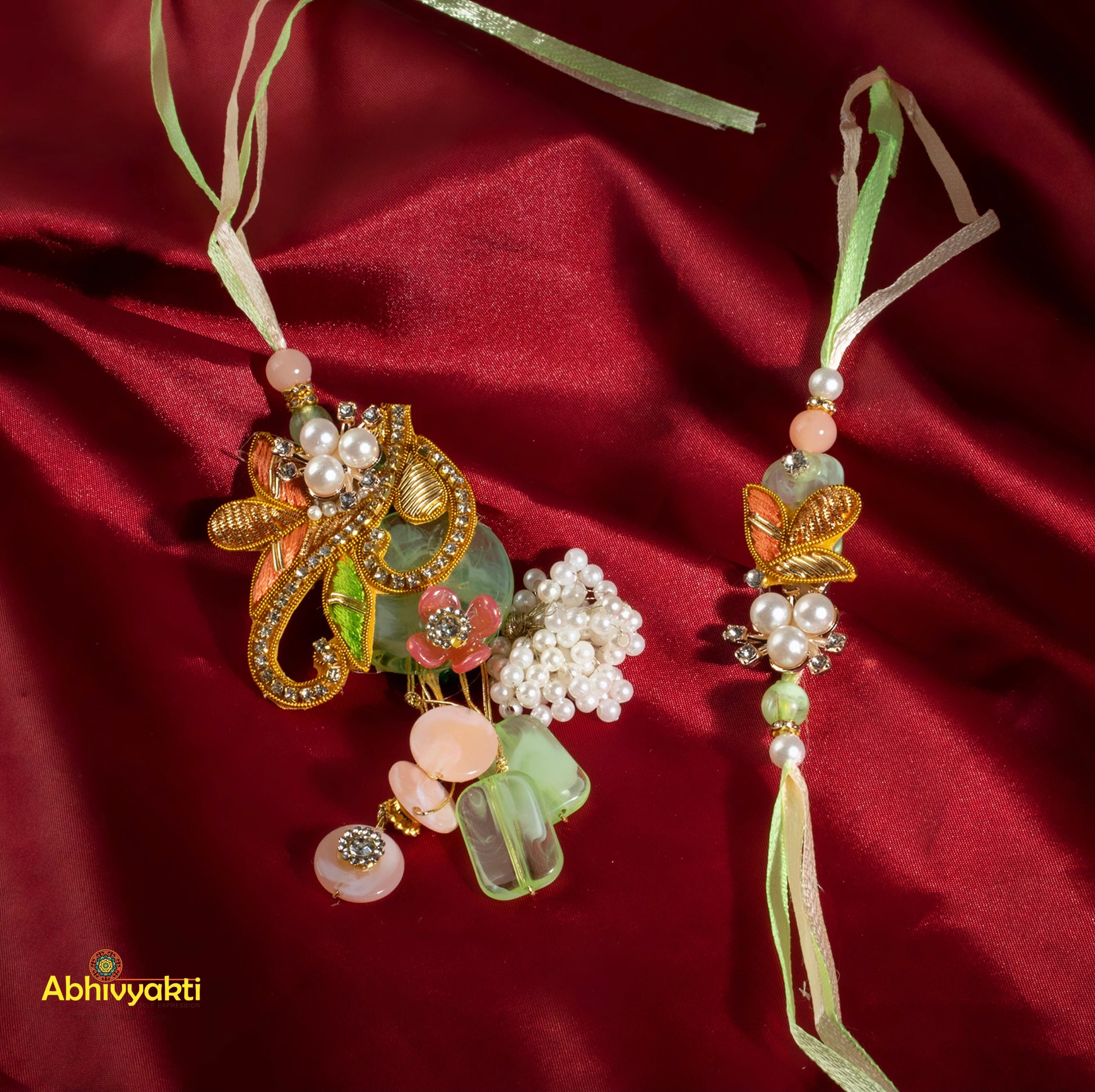 Elegant stone rakhi lumba featuring flowers and beads on red satin.