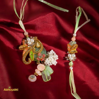 Elegant stone rakhi lumba featuring flowers and beads on red satin.