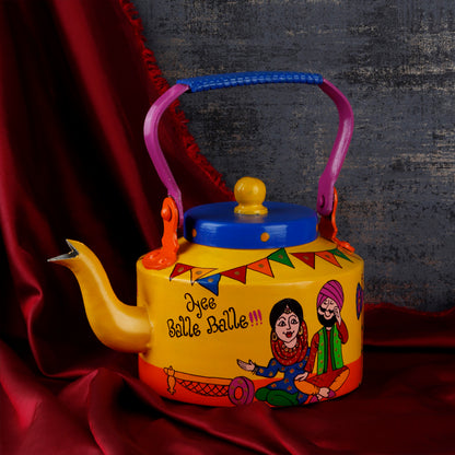 "A vibrant, handpainted kettle with quirky designs and bold colors, featuring intricate Indian folk art. The kettle is adorned with playful motifs and patterns, perfect as a decorative statement piece for a creative and culturally inspired home."