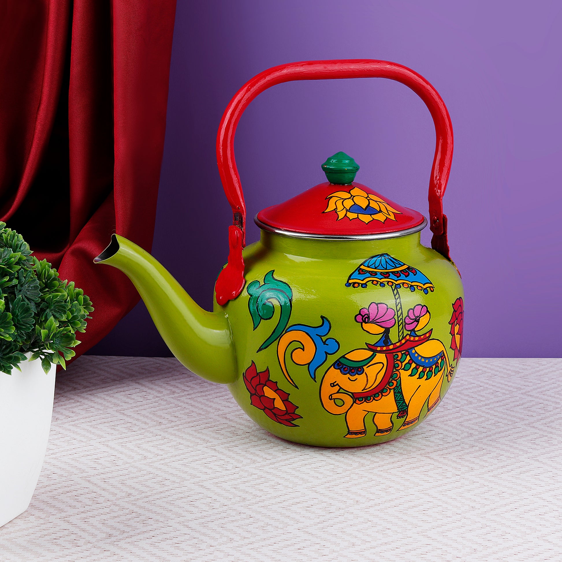 "A vibrant, handpainted kettle with quirky designs and bold colors, featuring intricate Indian folk art. The kettle is adorned with playful motifs and patterns, perfect as a decorative statement piece for a creative and culturally inspired home."