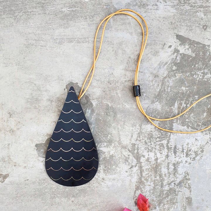 Our foray into the exquisite silver inlay craft of Bidri has always be unique and original. Waterdrop Boho Bidri Adjustable Necklace is inspired from the theme of water and the ever needful drop that quenches our universe.

These statement pieces are handcrafted in Bidar, North Karnataka. This piece is an ode to the waves of the sea. The metal used is a blackened alloy of zinc and copper inlaid with thin sheets of pure silver, brass and copper. Any imperfections on it are part of the handmade process involv
