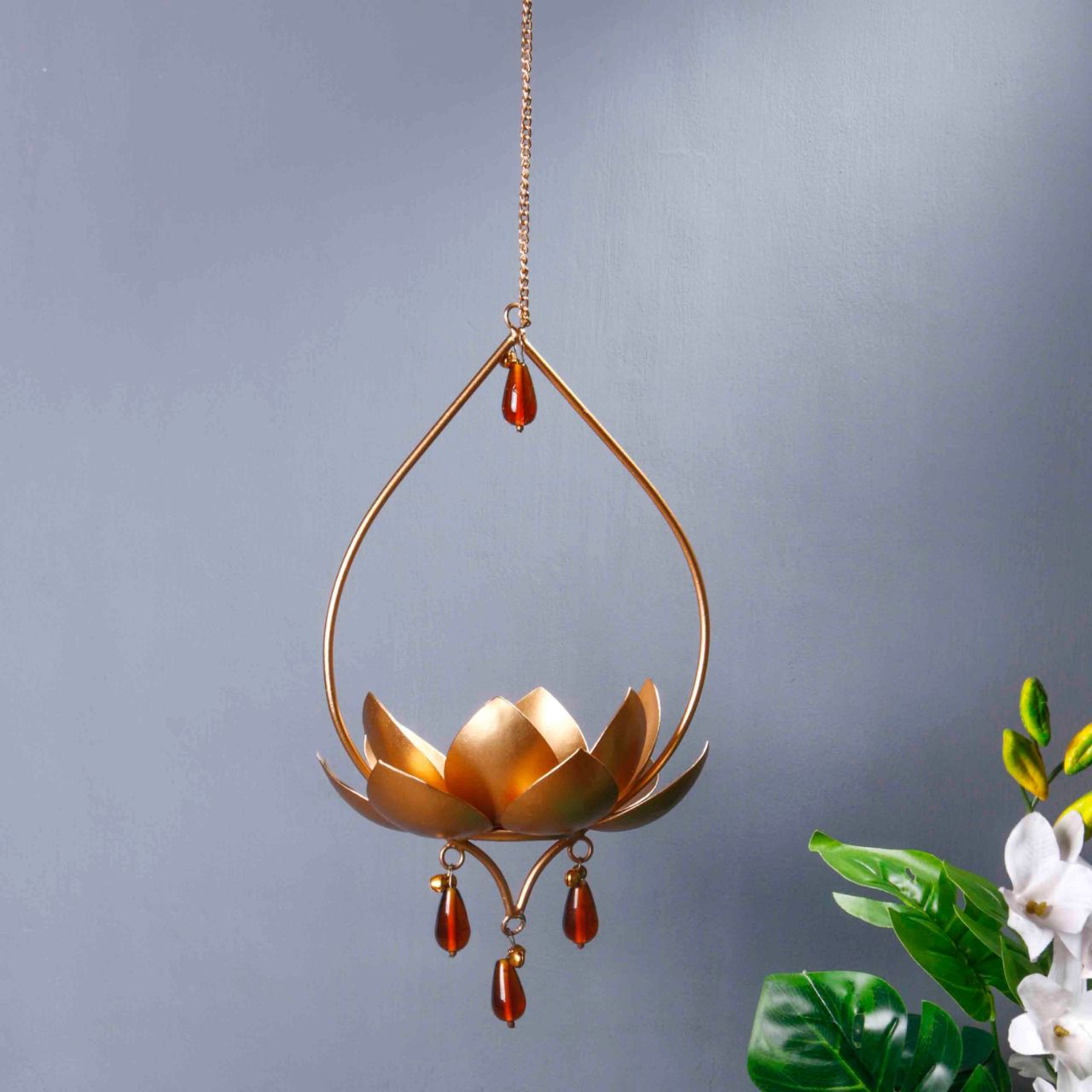 "Elegant wall-mounted Diwali diyas with intricate metal holders, designed to hang on the wall for a unique and stylish look. The diyas cast a soft, flickering light, creating a serene and festive ambiance for Diwali celebrations."
