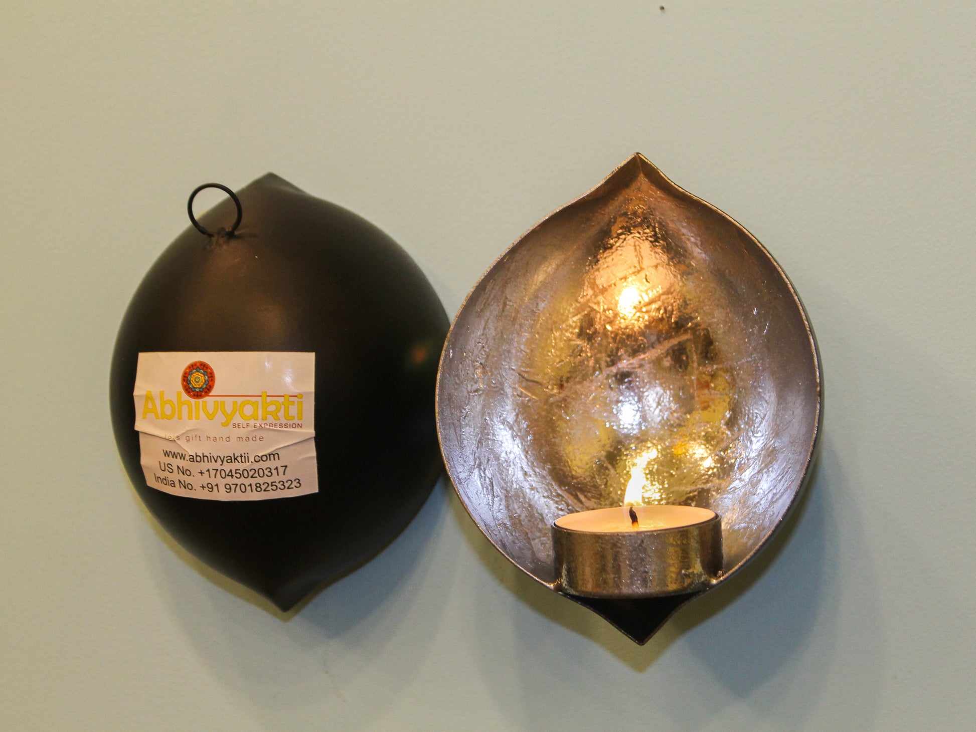 beautiful droplet shaped silver colored wall mounted tealight diya