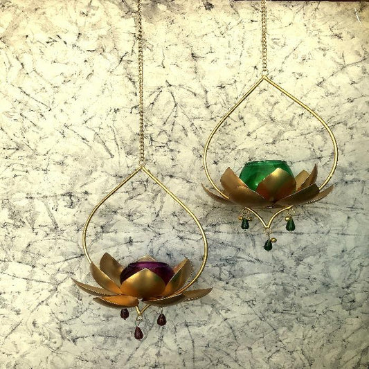 "Elegant wall-mounted Diwali diyas with intricate metal holders, designed to hang on the wall for a unique and stylish look. The diyas cast a soft, flickering light, creating a serene and festive ambiance for Diwali celebrations."